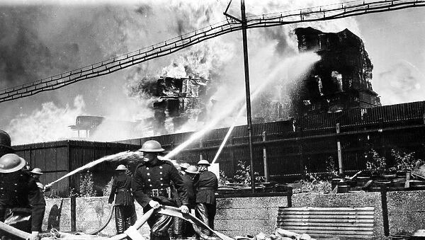 Timber yard fire, Walinden Road, Hackney. One section of the timber stacks shown burning