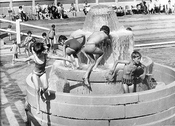 Time to cool off because, for once, the sun is shining. children splash about inTynemouth