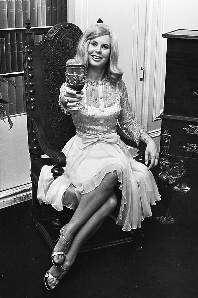 Tina Moore 23, wife of England Captain Bobby Moore, trying on the new dress she will wear