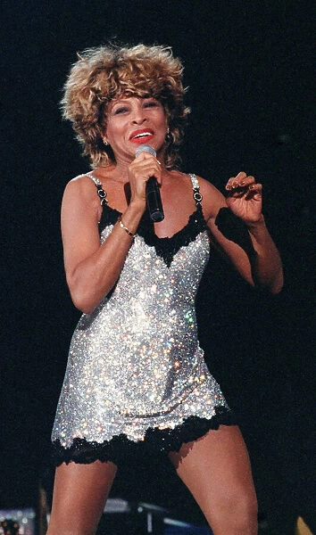 Tina Turner performing live on stage at the SECC Glasgow wearing a silver mini dress with