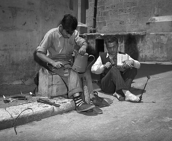 Tinkers in Malta 1954 Joseph Borg bare footed and Saviour Zammit both of Guida repair
