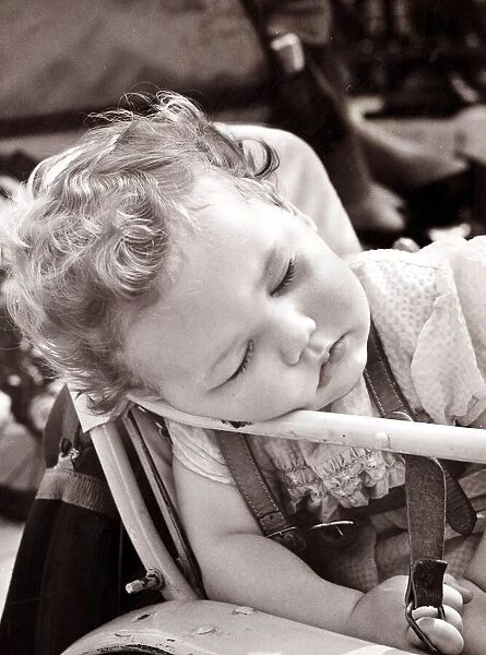 Tired baby in pram, circa 1950