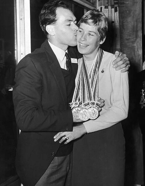 Tokyo Gold Medalist Mary Rand is met by her husband Sid on her return from the Olympic