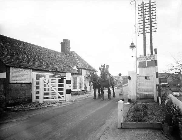 The toll is taken from a farmer and his team of two shire plough horses at the Swinford