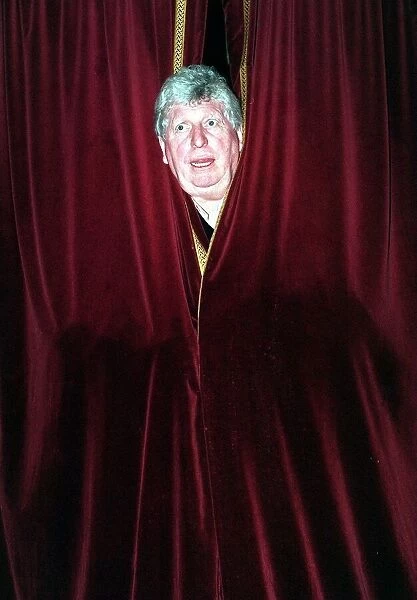 Tom Baker British actor Dec 1998 Peering out from behind stage curtains