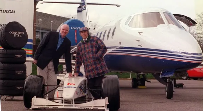 Framed Print : Tom Hunter with Jackie Stewart March 1999 with a race car with the new Lear Jet Framed Print : Tom Hunter with Jackie Stewart March 1999 with a race car with the new Lear Jet