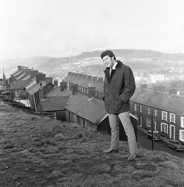 Tom Jones, a boy on top of the world, sings from the mountain top above his hometown of