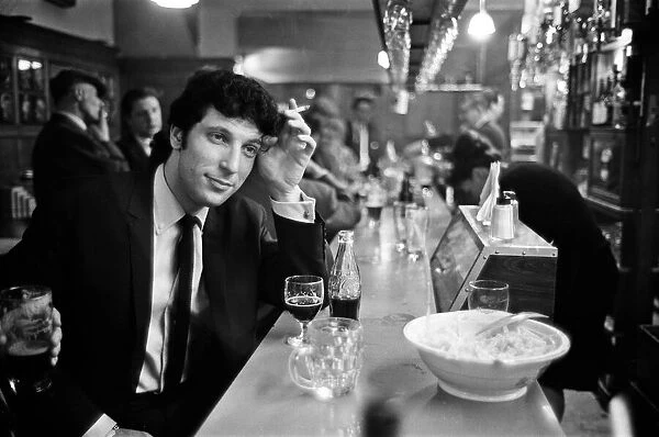Tom Jones enjoys a drink. 22nd February 1965