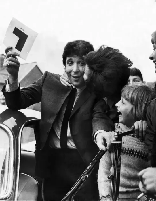 Framed Print : Tom Jones gets a kiss from a fan as he passes his Driving Learners test at Newport