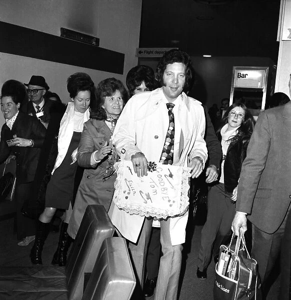 Tom Jones, surrounded by his fans, who bade him farewell as he left London for Los