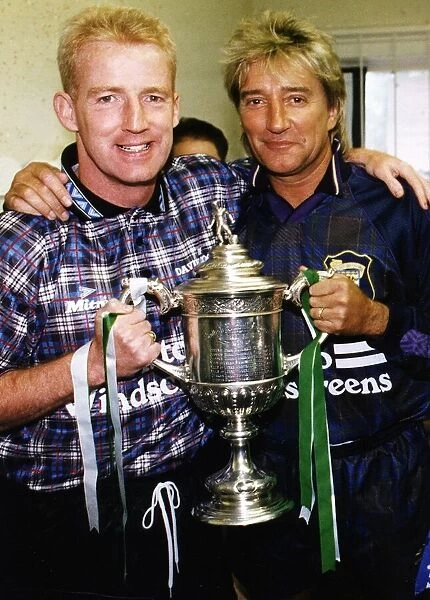 Tommy Burns Celtic football manager and singer Rod Stewart holding cup trophy at Davie