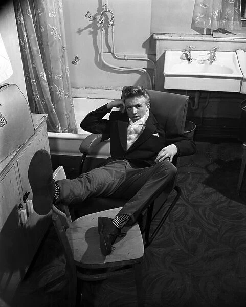 Tommy Steele resting in his dressing room. 1957