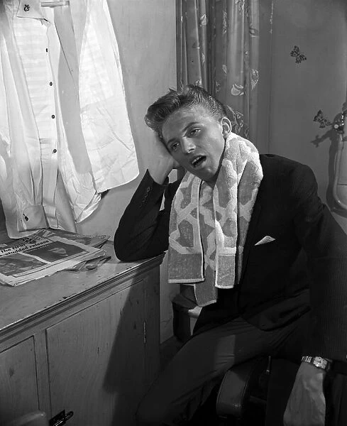 Tommy Steele resting in his dressing room. 1957