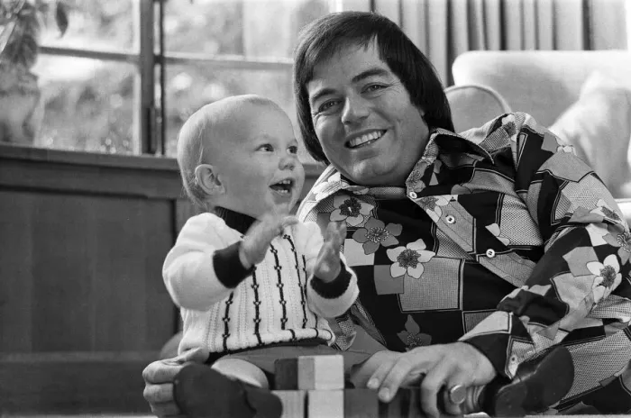 Framed Print : Tony Blackburn at home in Cookham Dean, Berkshire, with his son Simon. 5th September 1974 Framed Print : Tony Blackburn at home in Cookham Dean, Berkshire, with his son Simon. 5th September 1974