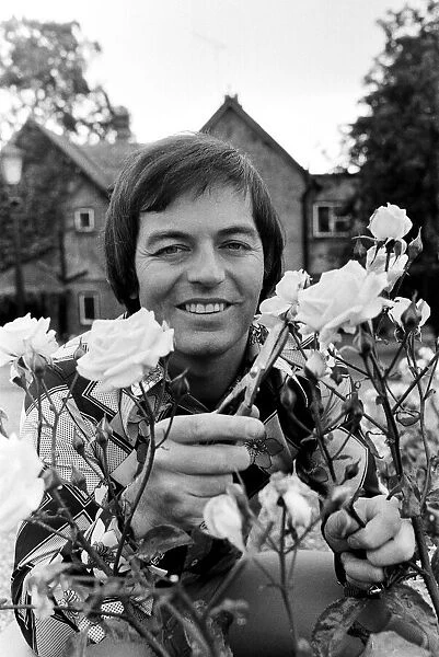 Tony Blackburn at home in Cookham Dean, Berkshire, pruning his roses. 5th September 1974
