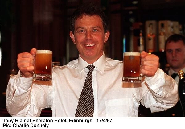 Tony Blair holding two half pints of Blairs Brew beer in both hands. April 1997