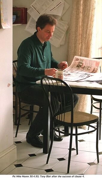 Tony Blair leader of the Labour Party at home in kitchen reading the newspapers after his