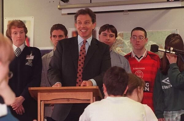 Tony Blair MP with children at Dyce Academy, standing at Lectern. 1990s