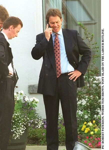 Tony Blair MP Labour Leader in a garden speaking into a mobile phone