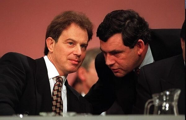 Tony Blair MP and Labour leader is spoken to on the platform by Gordon Brown shadow