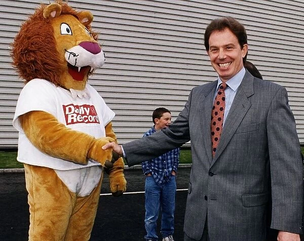 Tony Blair MP shaking hands with Daily Record mascot Roary the Lion at new printing plant