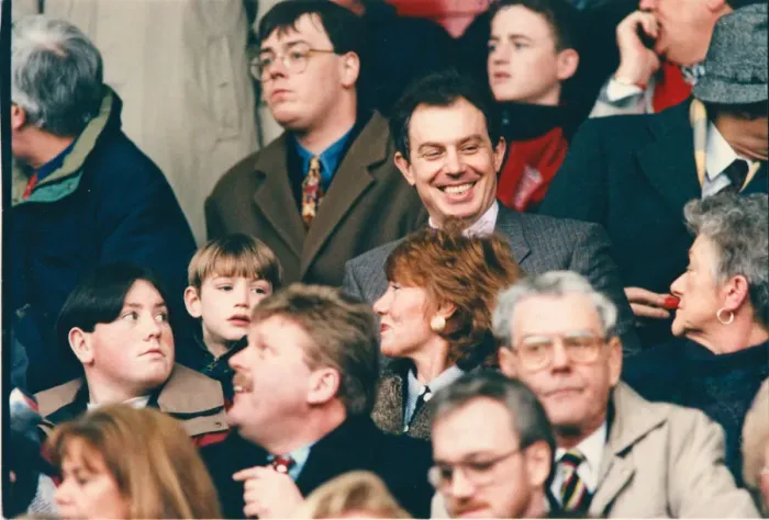 Framed Print : Tony Blair (smiling, above the red haired lady) in the crowd at Anfield