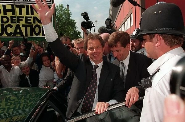 Tony Blair visits council estate in London June 1997, escorted by security through crowds
