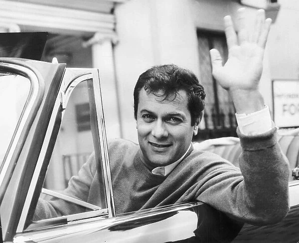 Tony Curtis, american actor poses for pictures in his Alvis TE21 motorcar in