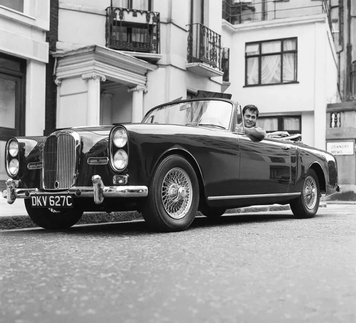 Framed Print : Tony Curtis, american actor poses for pictures in his Alvis TE21 motorcar in