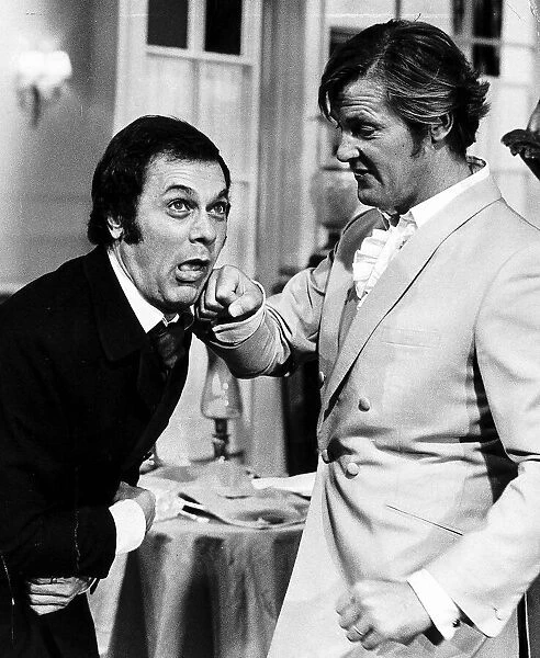 Tony Curtis and Roger Moore ham it up on the set of the Television series THE PERSUADERS