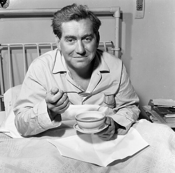 Tony Hancock pictured here from his hospital bed, 2nd August 1957
