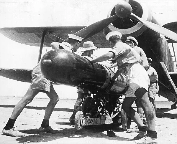 Torpedo being loaded on to an aeroplane of the Fleet Air Arm in the Mediterranean