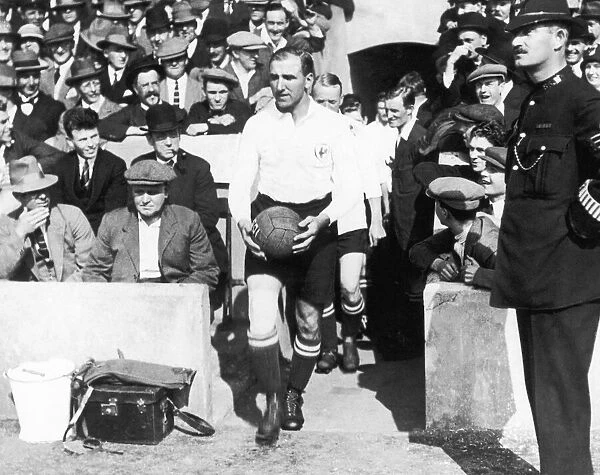 Tottenham Hotspur captain Arthur Grimsdell leads out his team for a match, circa 1920