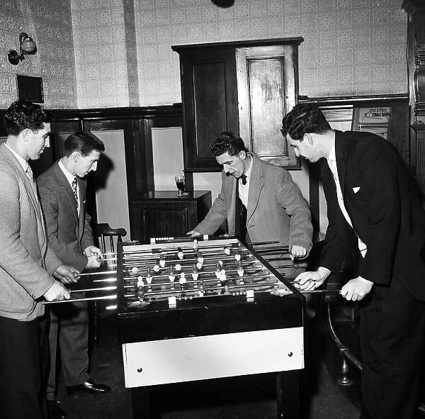 Tottenham Hotspur footballers enjoy a game of table football during a lunch time visit to