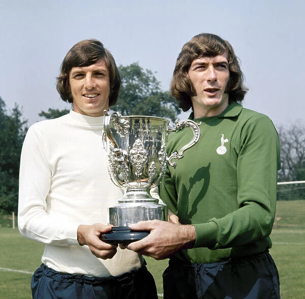 Tottenham Hotspur footballers Martin Peters (left) and pat Jennings shows off the League