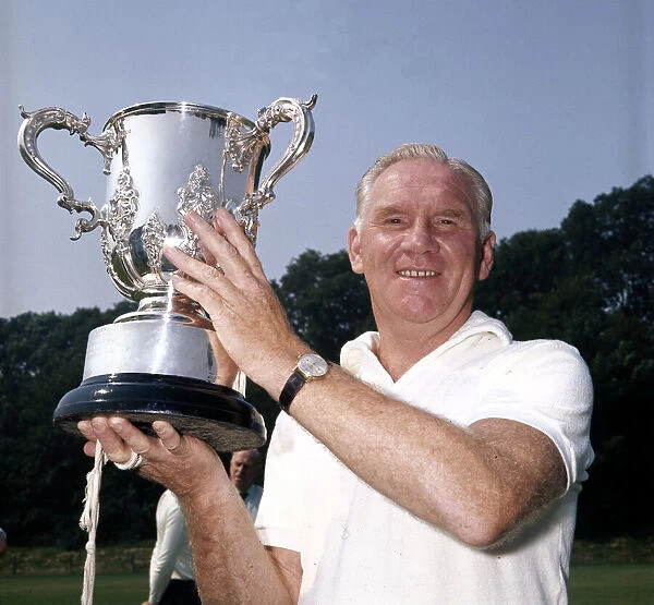 Tottenham Hotspur manager Bill Nicholson shows off the League Cup trophy at Spurs