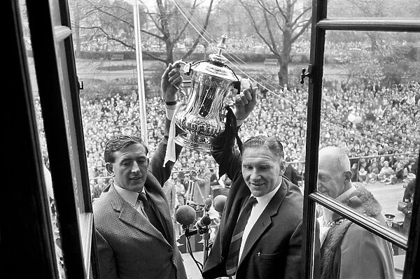 Tottenham Hotspur players parade the FA Cup trophy from the top of an open top double