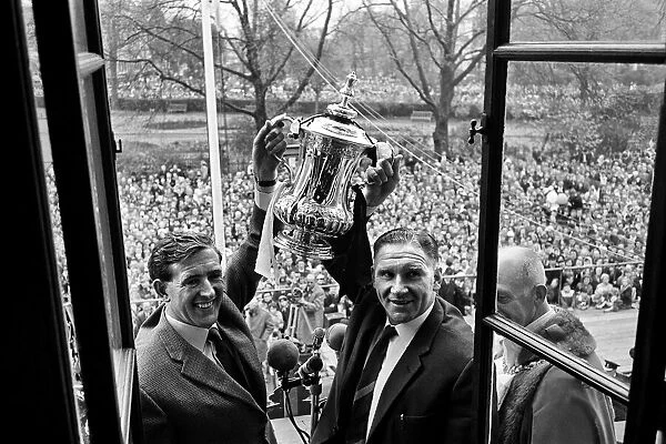 Tottenham Hotspur players parade the FA Cup trophy from the top of an open top double