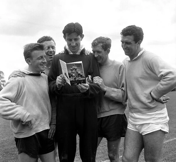 Tottenham Hotspur players reading a copy of the Spurs book called 'Spurs 1961'