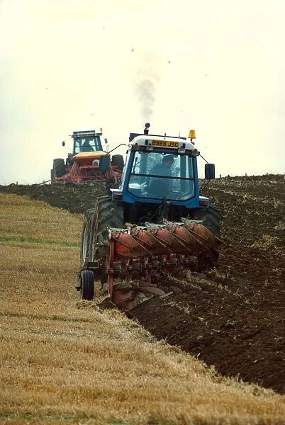 Tractors ploughing up a field