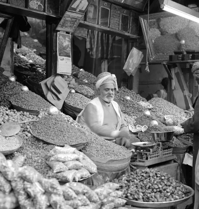 Framed Print : Trader in vegetables and spices sits outside his shop in Peshawar the capital of Framed Print : Trader in vegetables and spices sits outside his shop in Peshawar the capital of