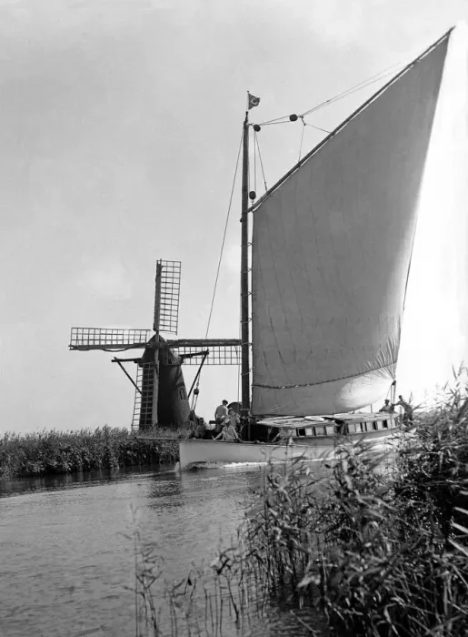 Framed Print : A traditional Norfolk Broad yachts sailing past one of the many windmill water pumps that Framed Print : A traditional Norfolk Broad yachts sailing past one of the many windmill water pumps that