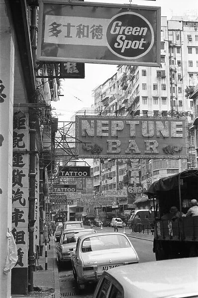 Traffic and signs advertising night clubs, tattoo and massage parlours seen here