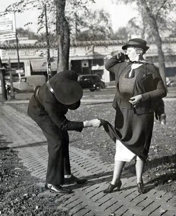 Framed Print : A traffic warden lifts the hem of a ladys dress to reveal her petticoats Framed Print : A traffic warden lifts the hem of a ladys dress to reveal her petticoats