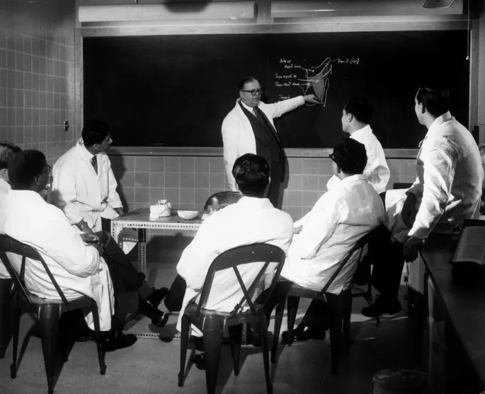 Framed Print : Trainee doctors being given instruction on the blackboard during a lecture Framed Print : Trainee doctors being given instruction on the blackboard during a lecture