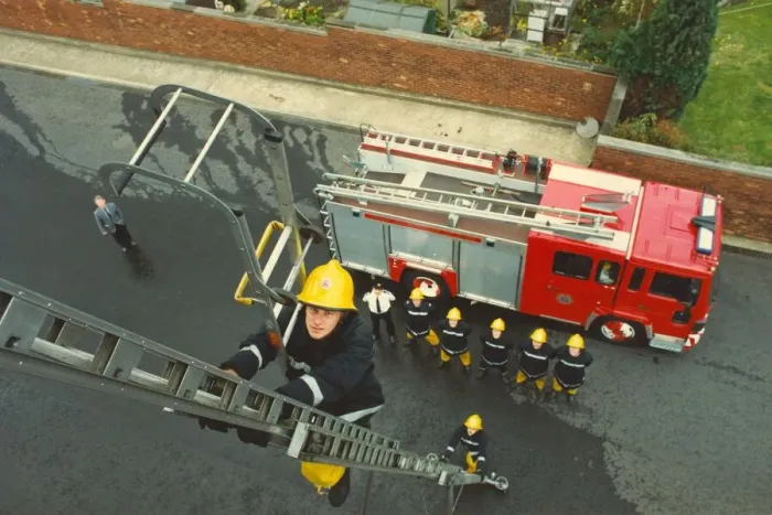 Framed Print : A training exercise in the centre of Newcastle - firefighter Sean McHee shows how to