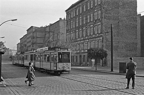 A tram runs along Bernauer Strasse, Berlin. The buildings on the east side of the street