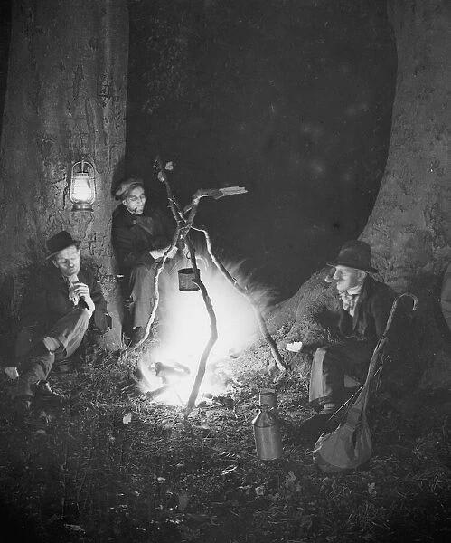 Tramps at night by a camp fire Circa 1930
