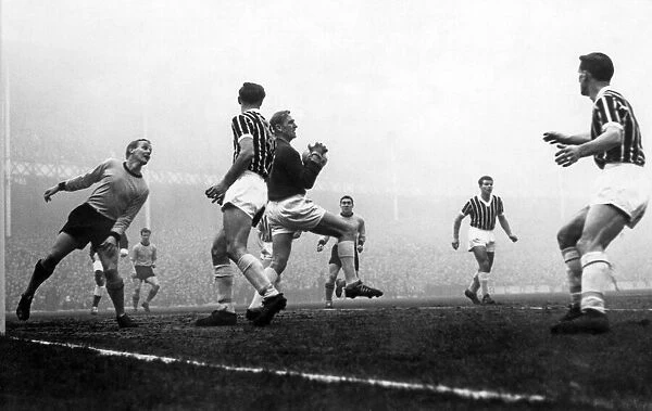 Trautmann is well supported by Manchester City defenders as he catches a shot from Vernon