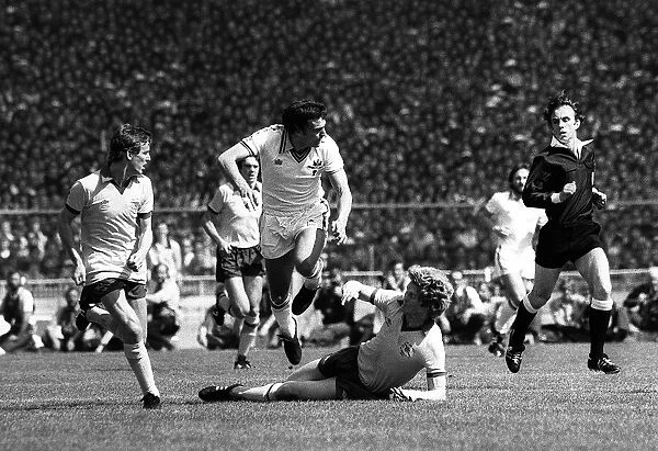 Trevor Brooking is brought down by Arsenals Willie Young during the FA Cup final at